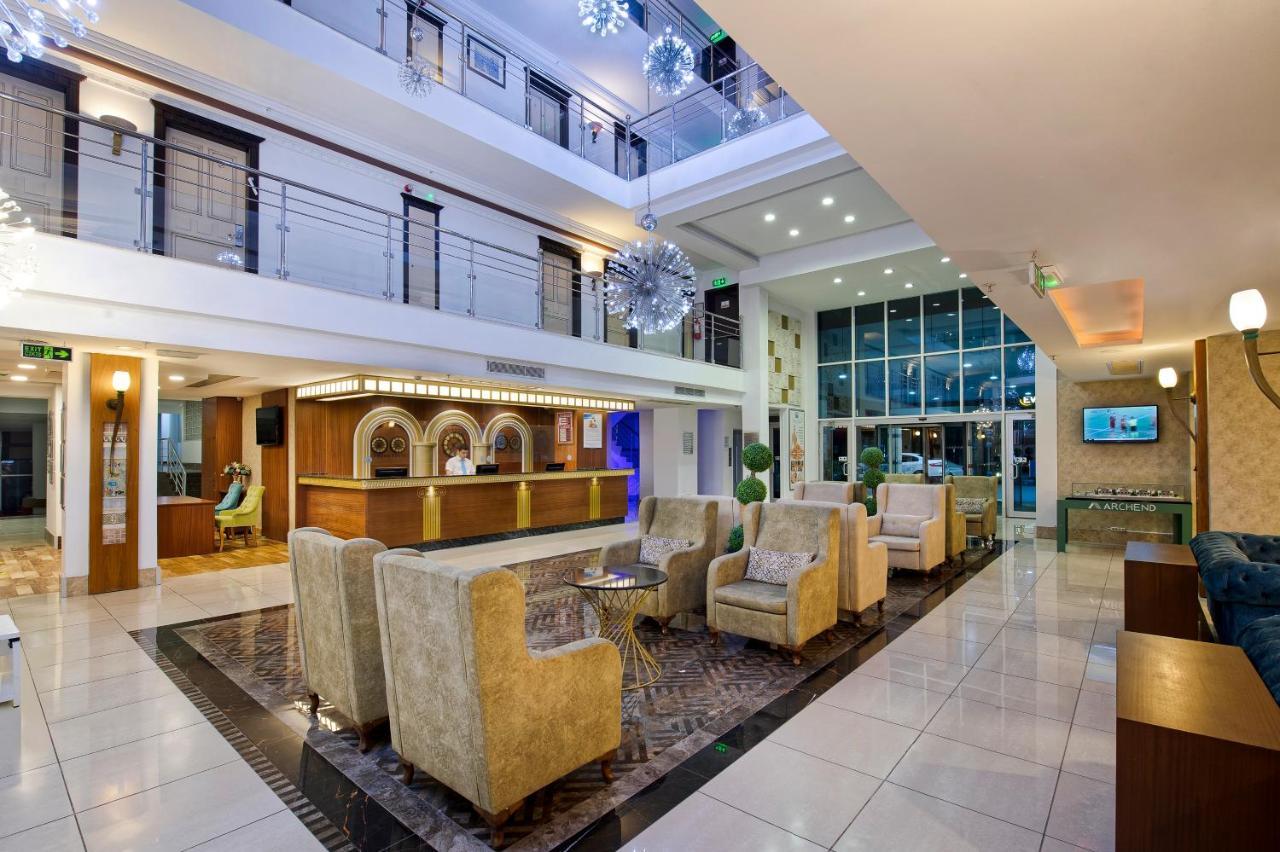 Sealife Family Resort Hotel Antalya Exterior foto The image depicts a modern hotel lobby. The space features an open design with multiple levels visible. It has a bright and welcoming atmosphere, highlighted by large windows that allow natural light to flood the area. 

The seating arrangement inclu