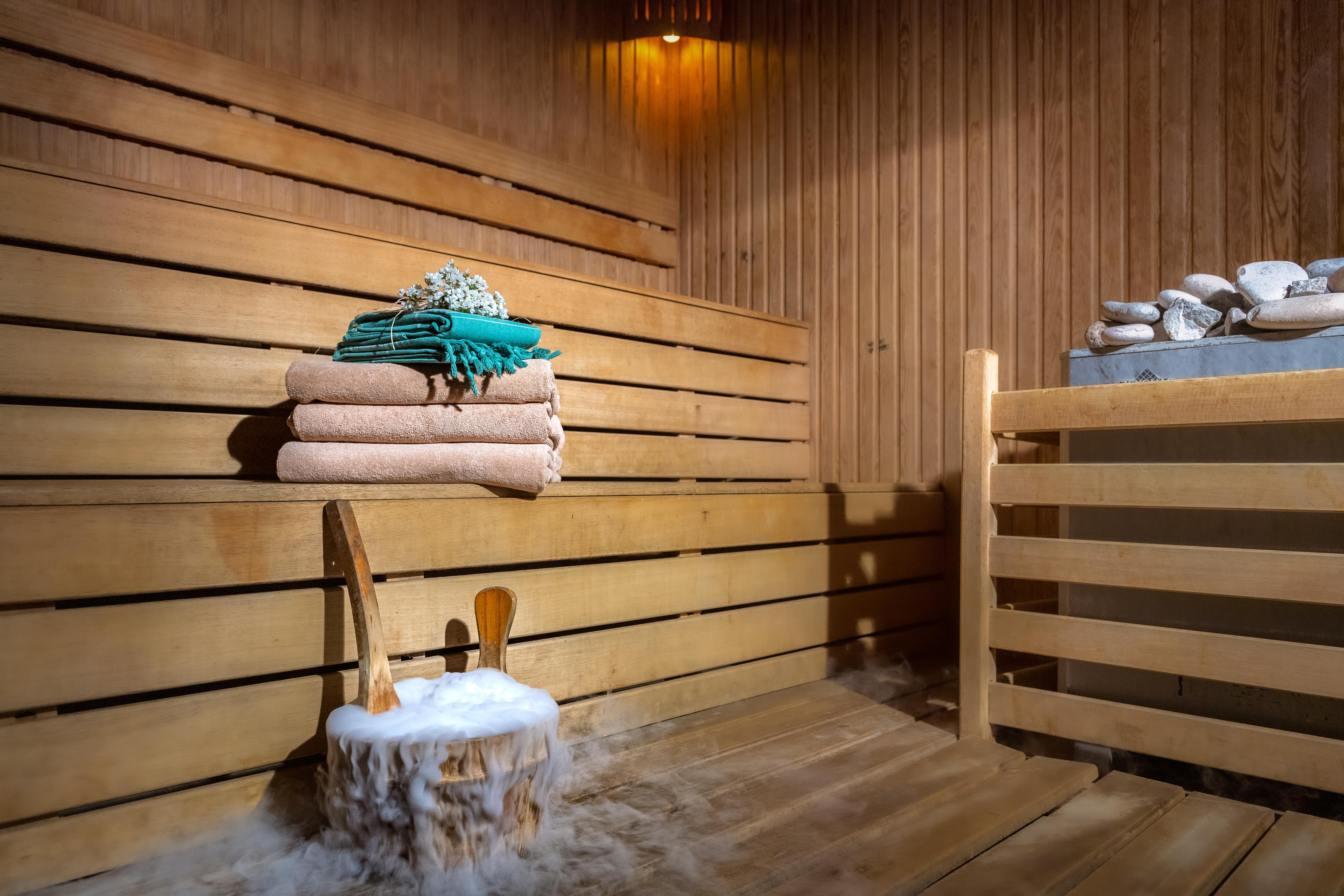 Sealife Family Resort Hotel Antalya Exterior foto The photo shows the interior of a sauna. It features wooden walls and benches, creating a warm and inviting atmosphere. On the benches, there are neatly stacked towels in different colors, including green and beige. In the foreground, there's a woode
