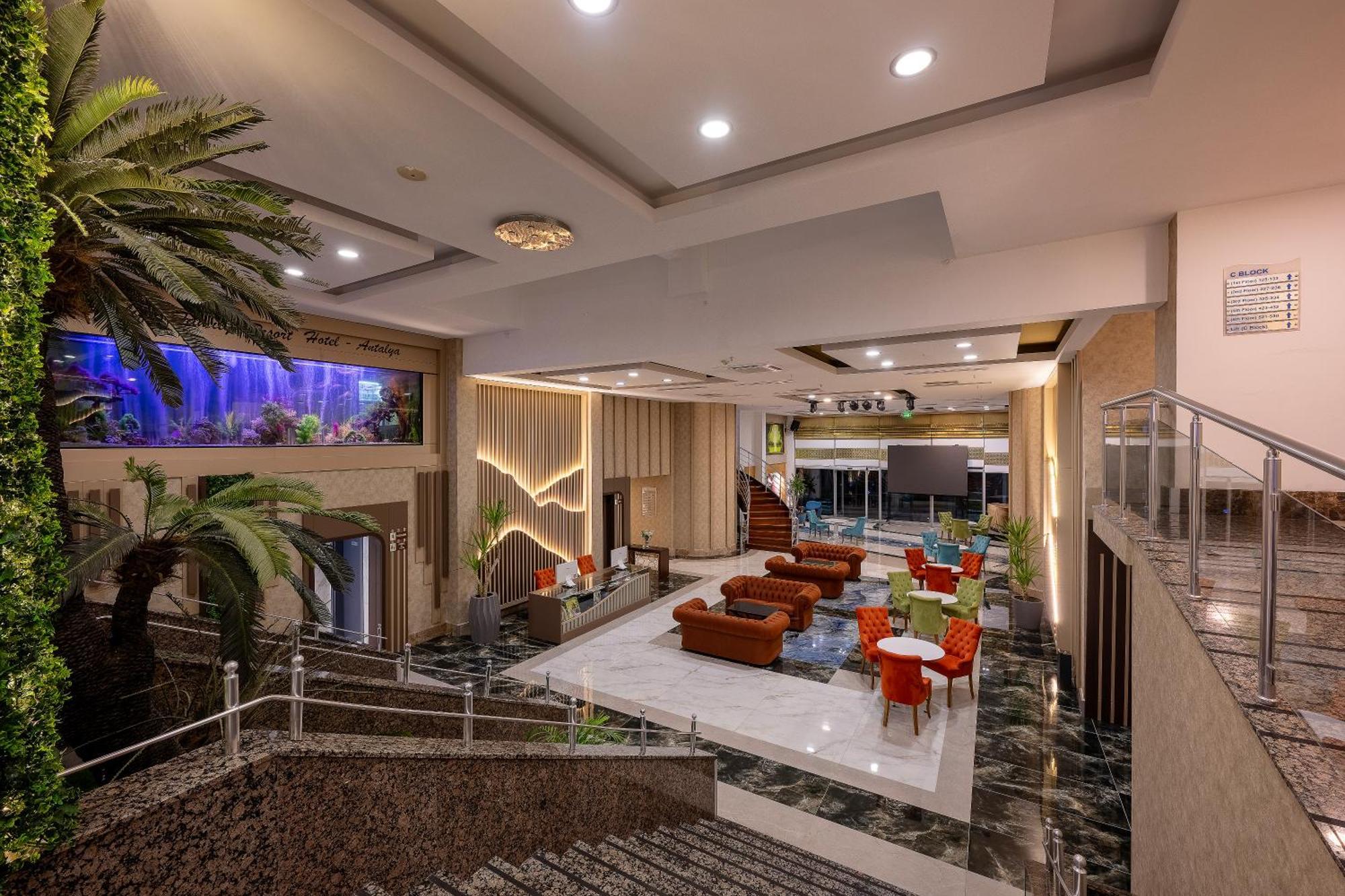 Sealife Family Resort Hotel Antalya Exterior foto The photo shows a spacious and modern lobby area of a building, possibly a hotel. It features a combination of elegant decor and comfortable seating arrangements. There are large windows allowing natural light in, and the space includes a mix of indo